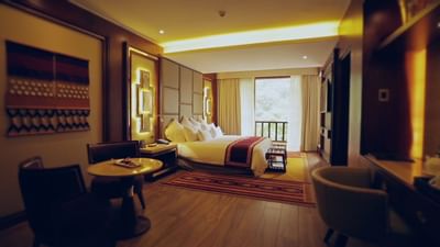 Junior Suite with river view with a kings bed at Hotel Sumaq