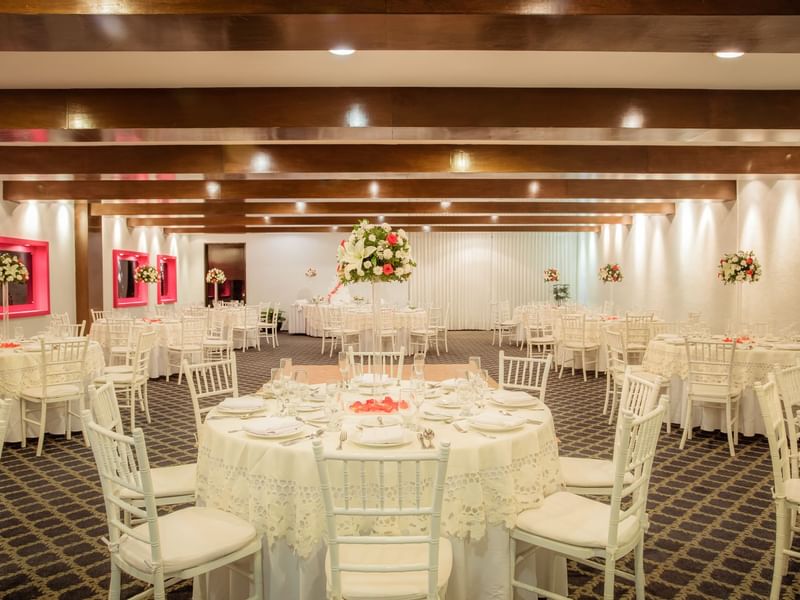 White-themed banquet tables at an event in Gamma Hotels