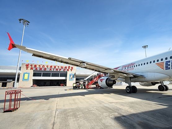 People getting on the plane at Trang Airport near Hop Inn Hotel