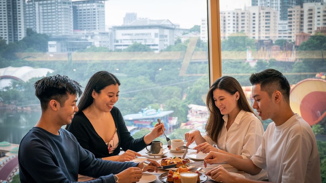 2 couples dining by a window with a view near Sunway Resort