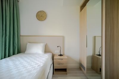 Bed with side table and closet in Interconnected Suites at The Hub Acunmeyda