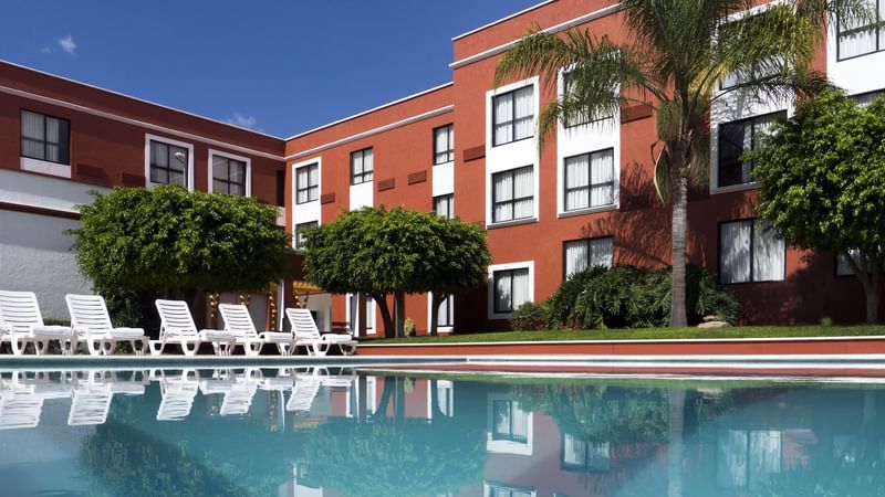 Outdoor swimming pool & sunbeds at Fiesta Inn León