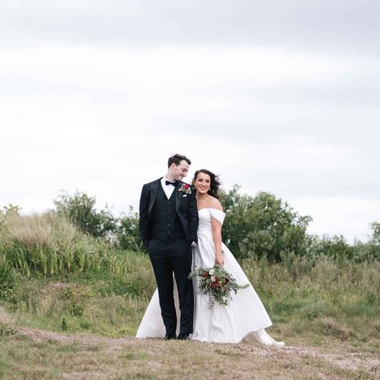 Wedding couple posing by the greenly area near Pullman Magenta Shores