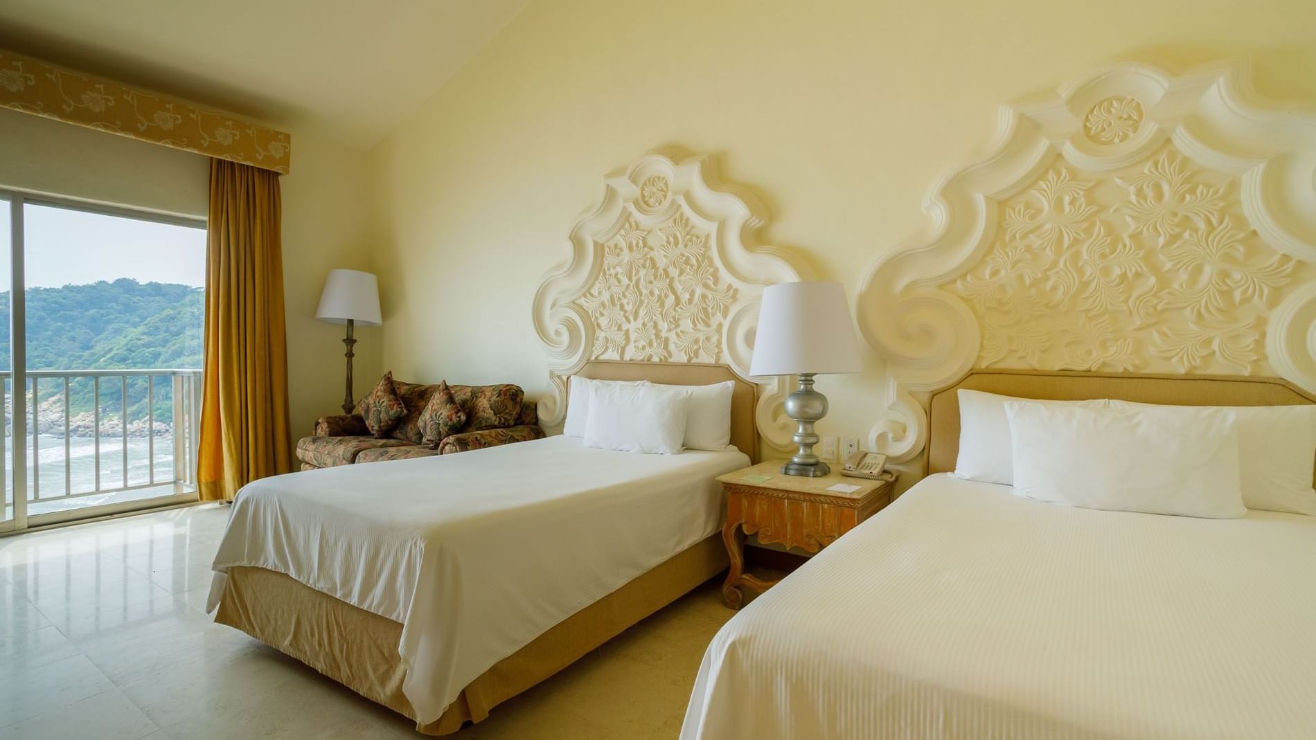 Coastal view from 2 Double Grand Class at Quinta Real Acapulco, featuring warm yellow tones and chic decor