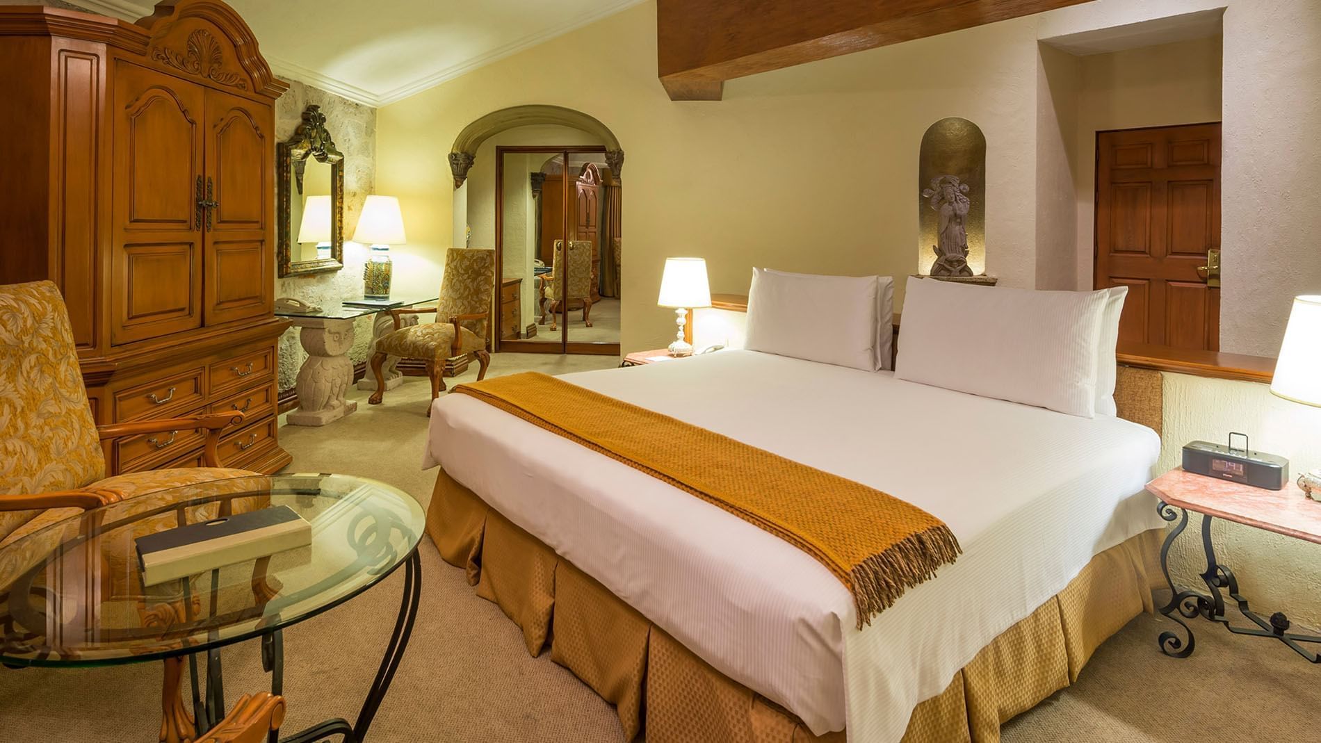 King Presidential Suite with a king bed and an ornate wooden wardrobe at Quinta Real Aguascalientes