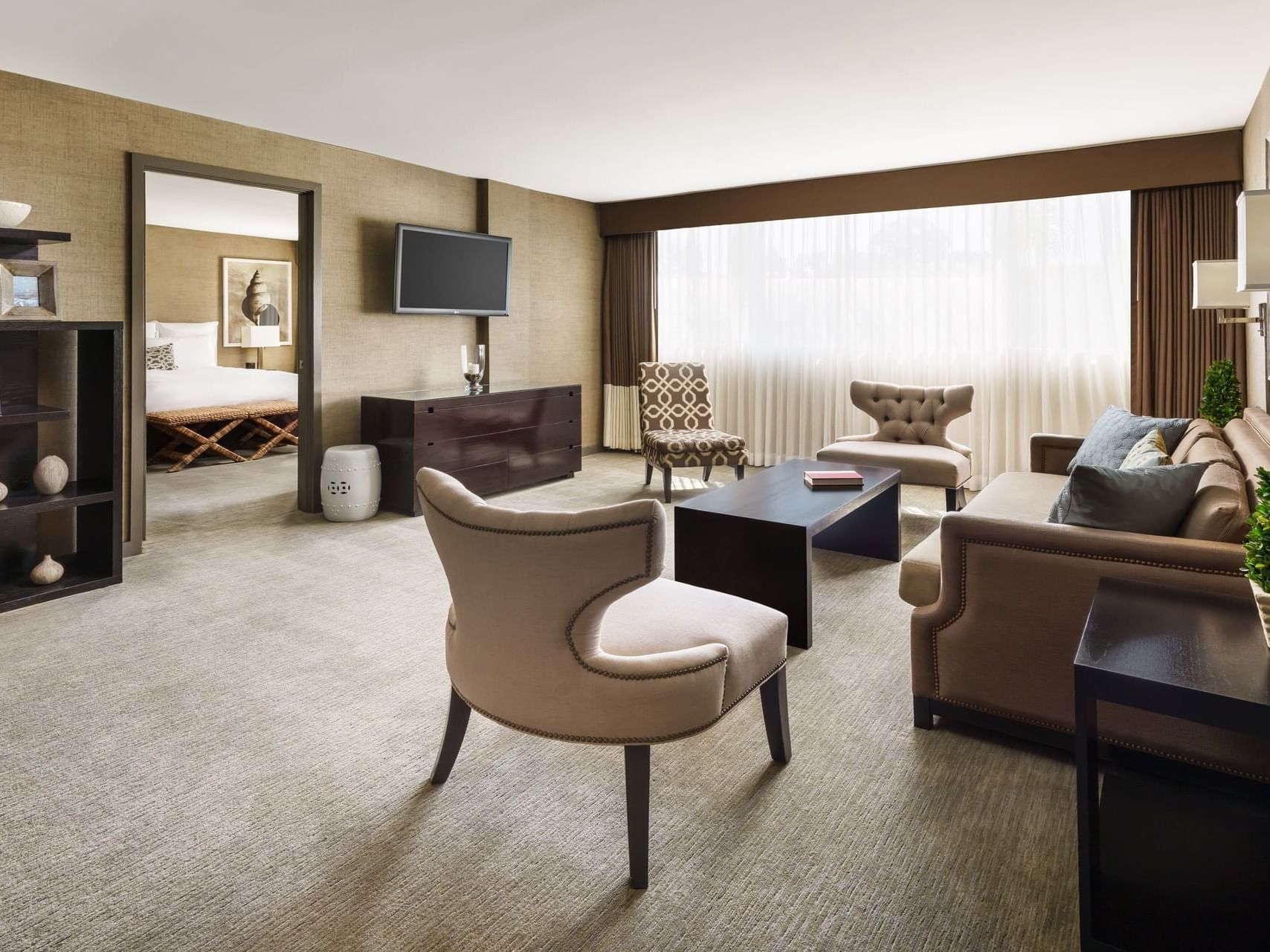 One-bedroom suite with a living area and bedroom at Luxe Sunset Boulevard Hotel