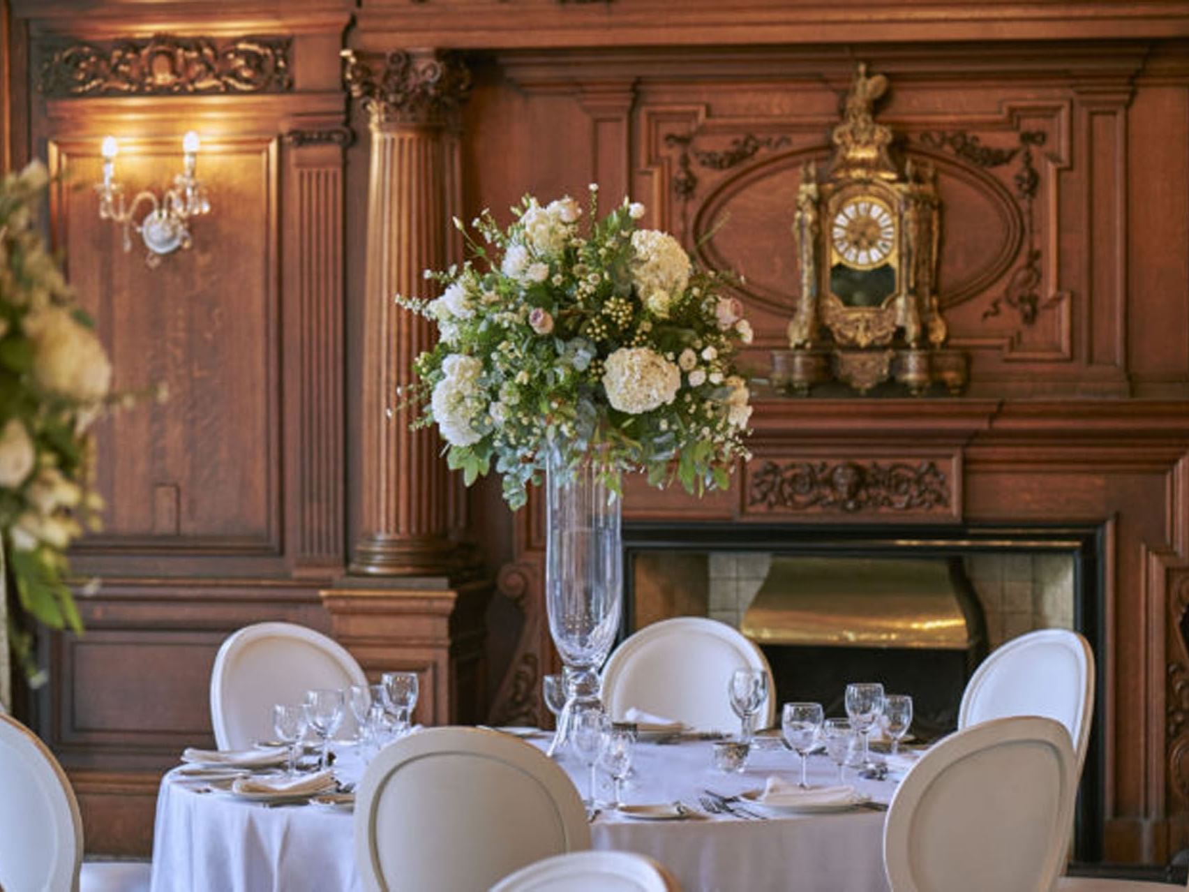 Dining room with floral centerpiece and ornate wooden fireplace featuring Classic York Wedding Package at The Milner York