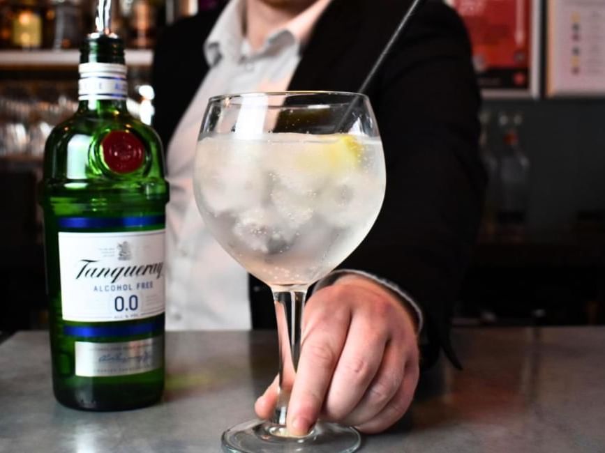 Bar staff serving gin at Dukes Bar in Buckingham