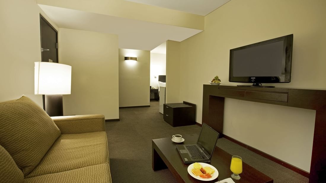 Living space of Junior Suite with TV at Fiesta Inn