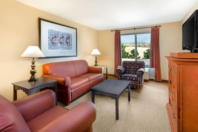 Cozy living room area in a suite at Hilton Santa Fe Buffalo Thunder with sofa, armchair, and soft lighting