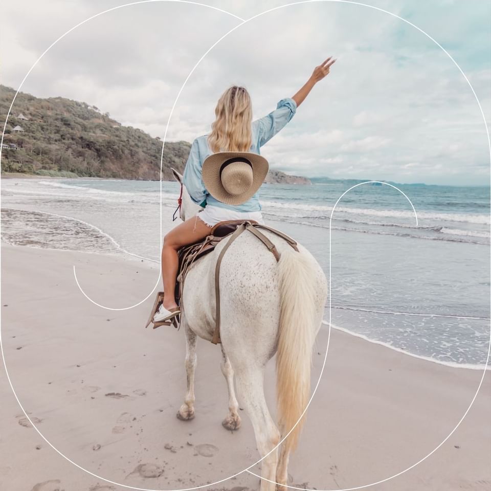 A lady riding a horse on the beach near Punta Islita Hotel