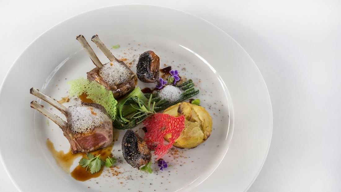 Meat dish served on a plate in Lagoon Terrace Restaurant at Warwick Le Lagon