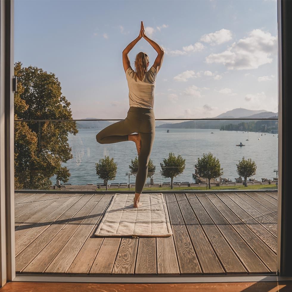 Lady doing yoga on a balcony with a view, Falkensteiner Hotels