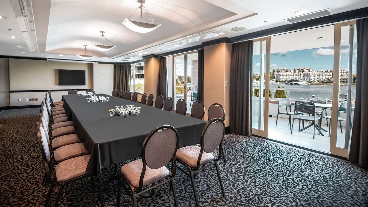 Meeting room with chairs, tables, and view of water