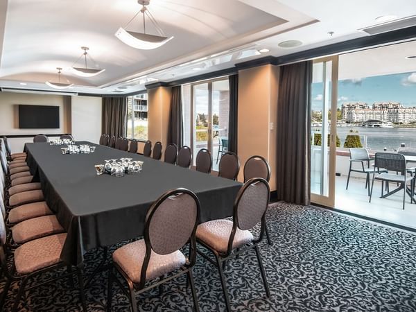 Meeting tables set up for event with view of water