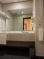 Bathroom featuring vanity and lavatory in Junior Suite at Naviti By Warwick Dammam