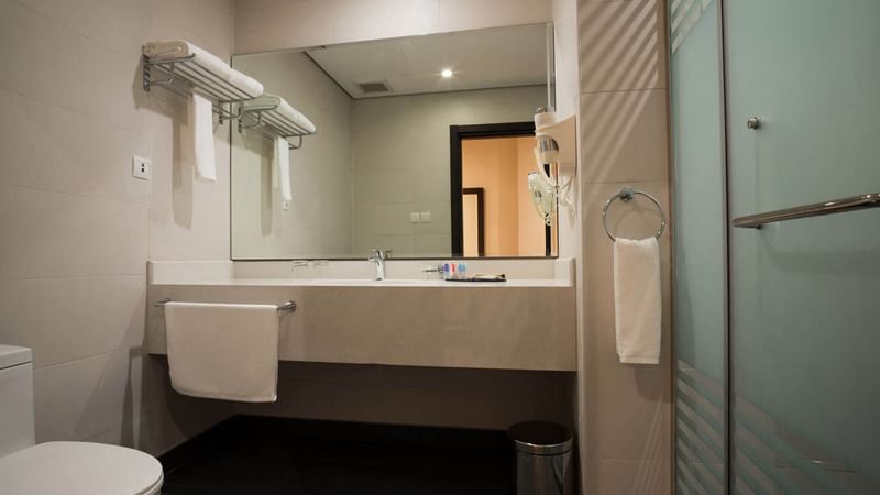 Bathroom with mirror & wash basin in Junior Suite at Naviti By Warwick Dammam
