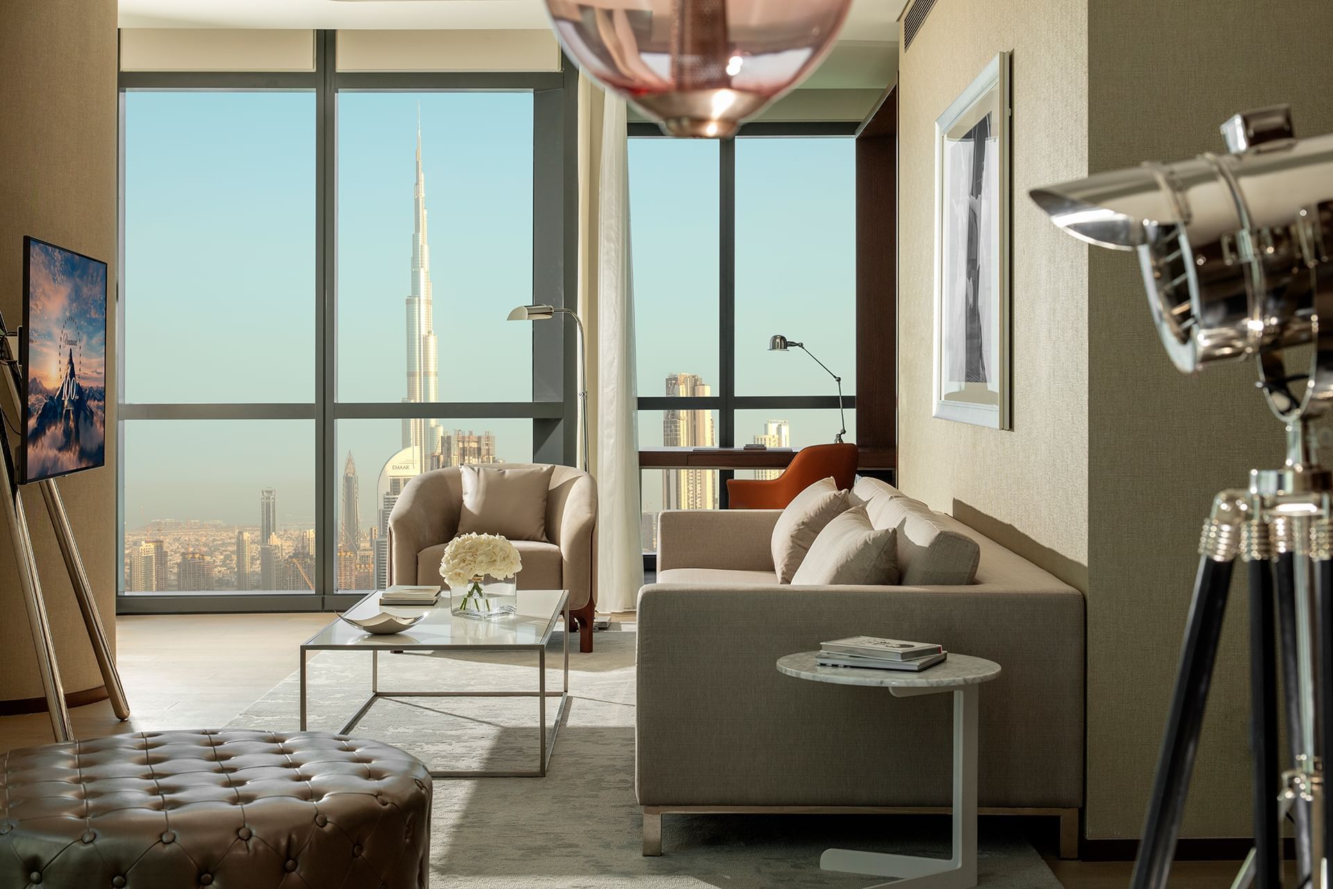 Lounge area with plush seating by large windows in Premier Suite with Panoramic View at Paramount Hotel Dubai