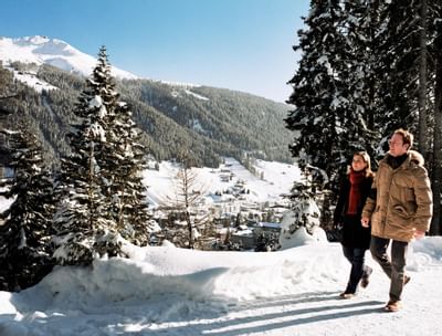 Couple walking among the Davos mountains