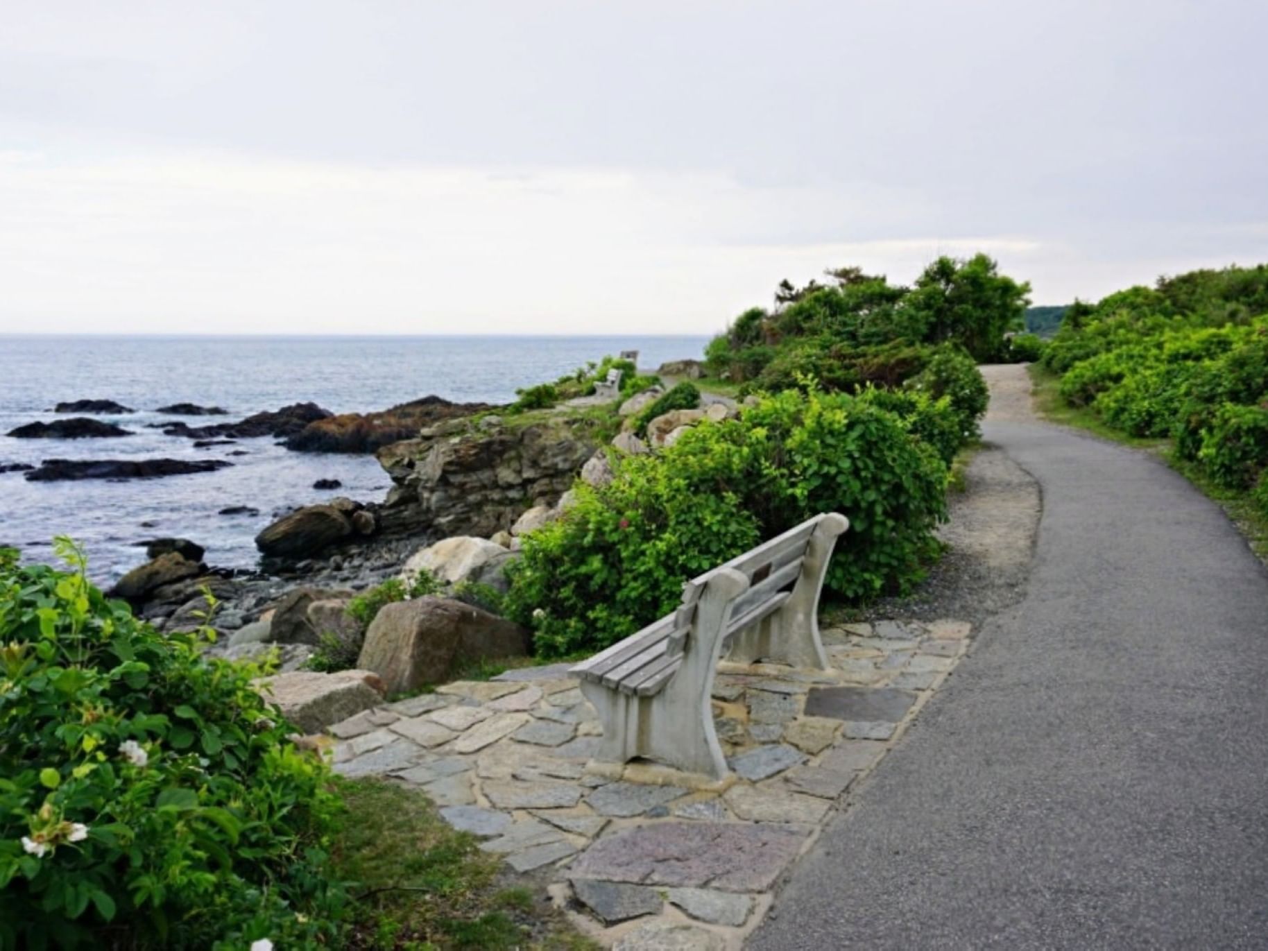 Bench by the beach with a nice cliffside view along a coastal trail in Marginal Way near Ogunquit River Inn