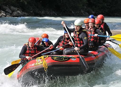 a group of people rafting on a river