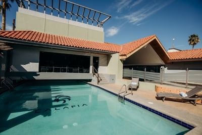 Sunbeds by the outdoor swimming pool at Araiza Hotel Calafia