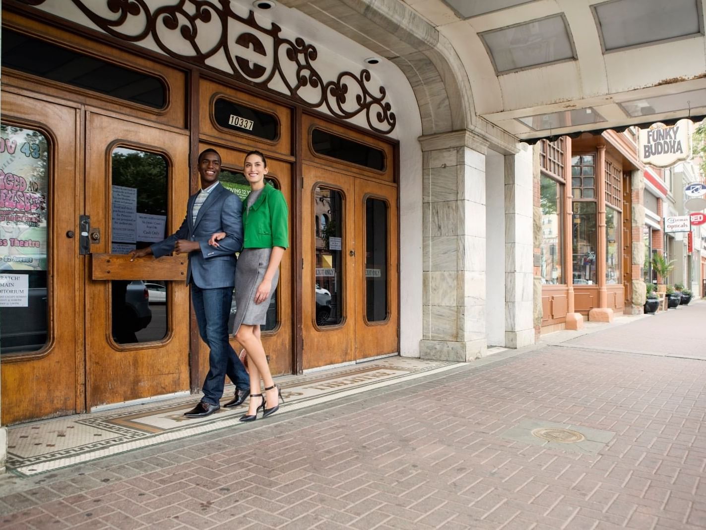 A couple walking on Whyte Avenue near Varscona Hotel on Whyte