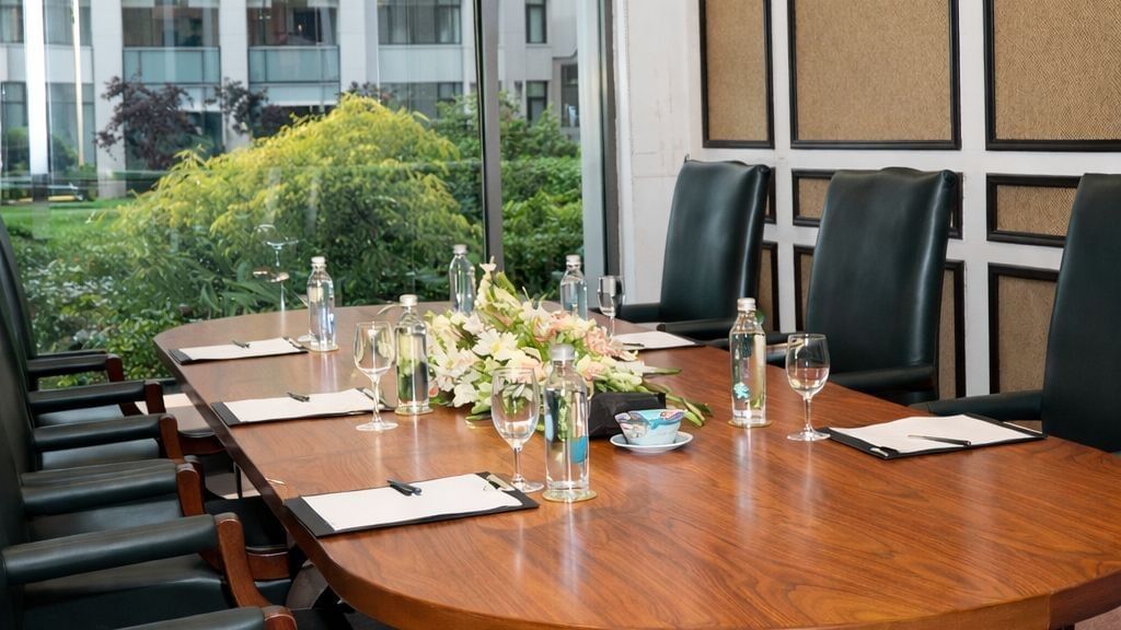 Oval meeting table by a garden window, perfect for small conferences in Asia at Serena Hotels & Resorts