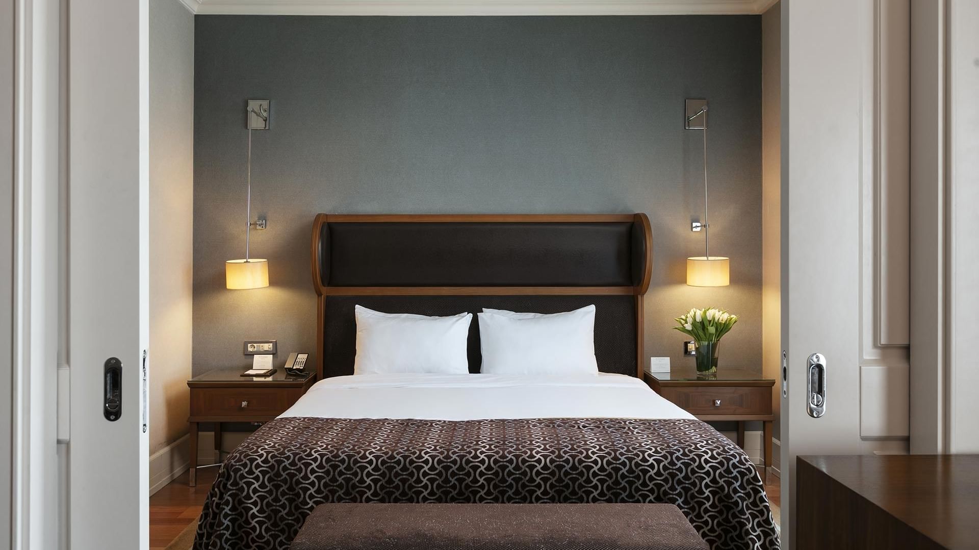 Double bed with cozy pillows and nightstands in Club Suite at Titanic Business Kartal