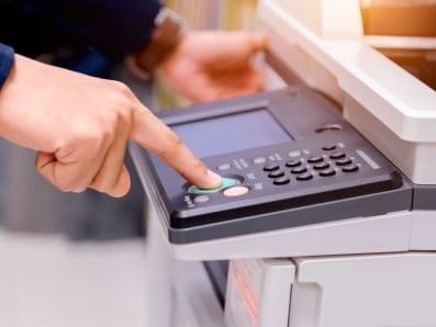 Close-up of person using a Photocopy machine in Business Support at Pensativo House Hotel