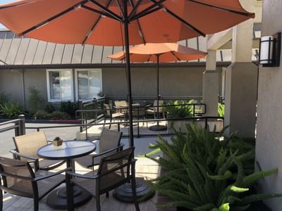 a table and chairs under an umbrella