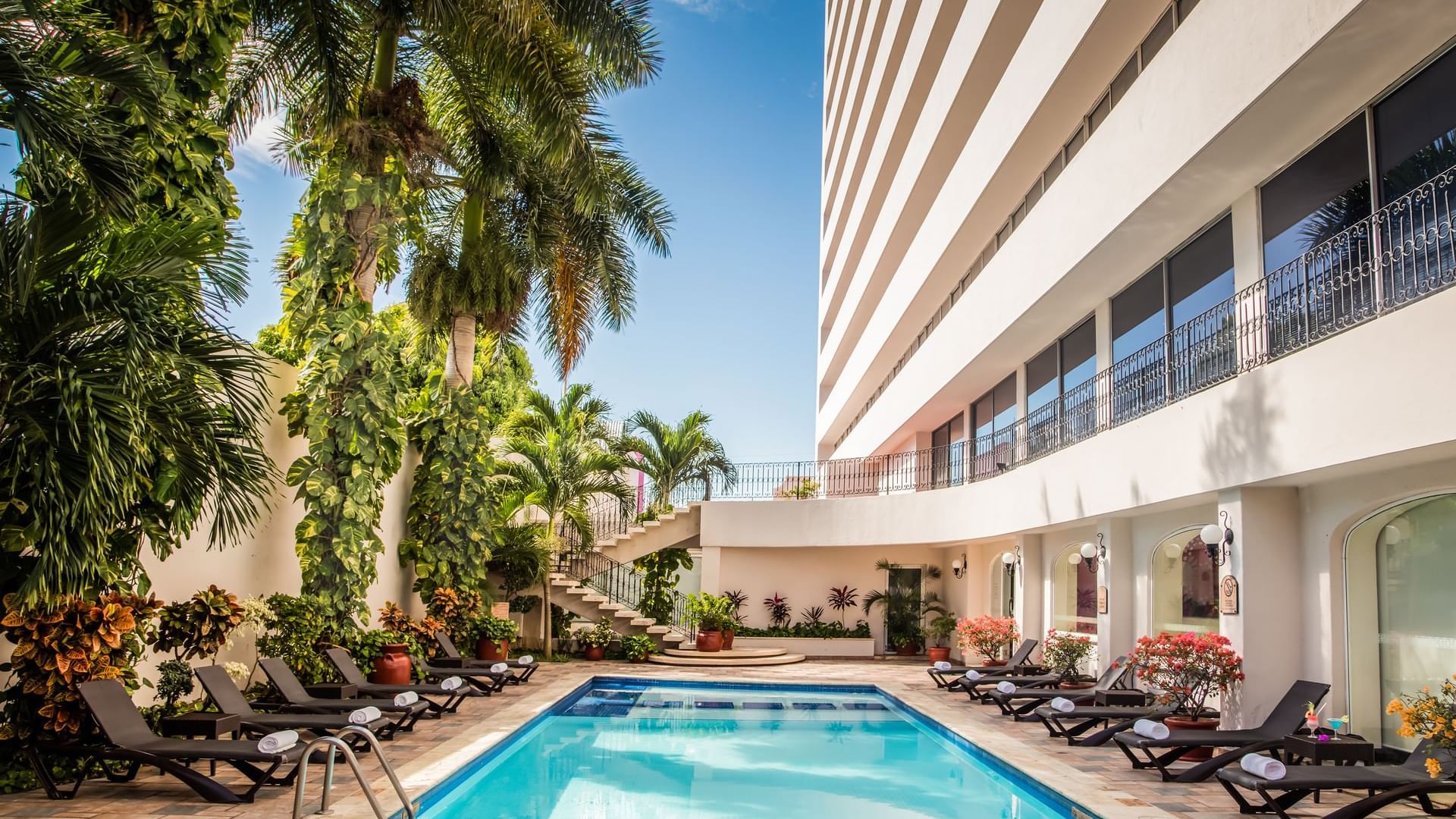 Sunbeds by the pool at Gamma Mérida el Castellano