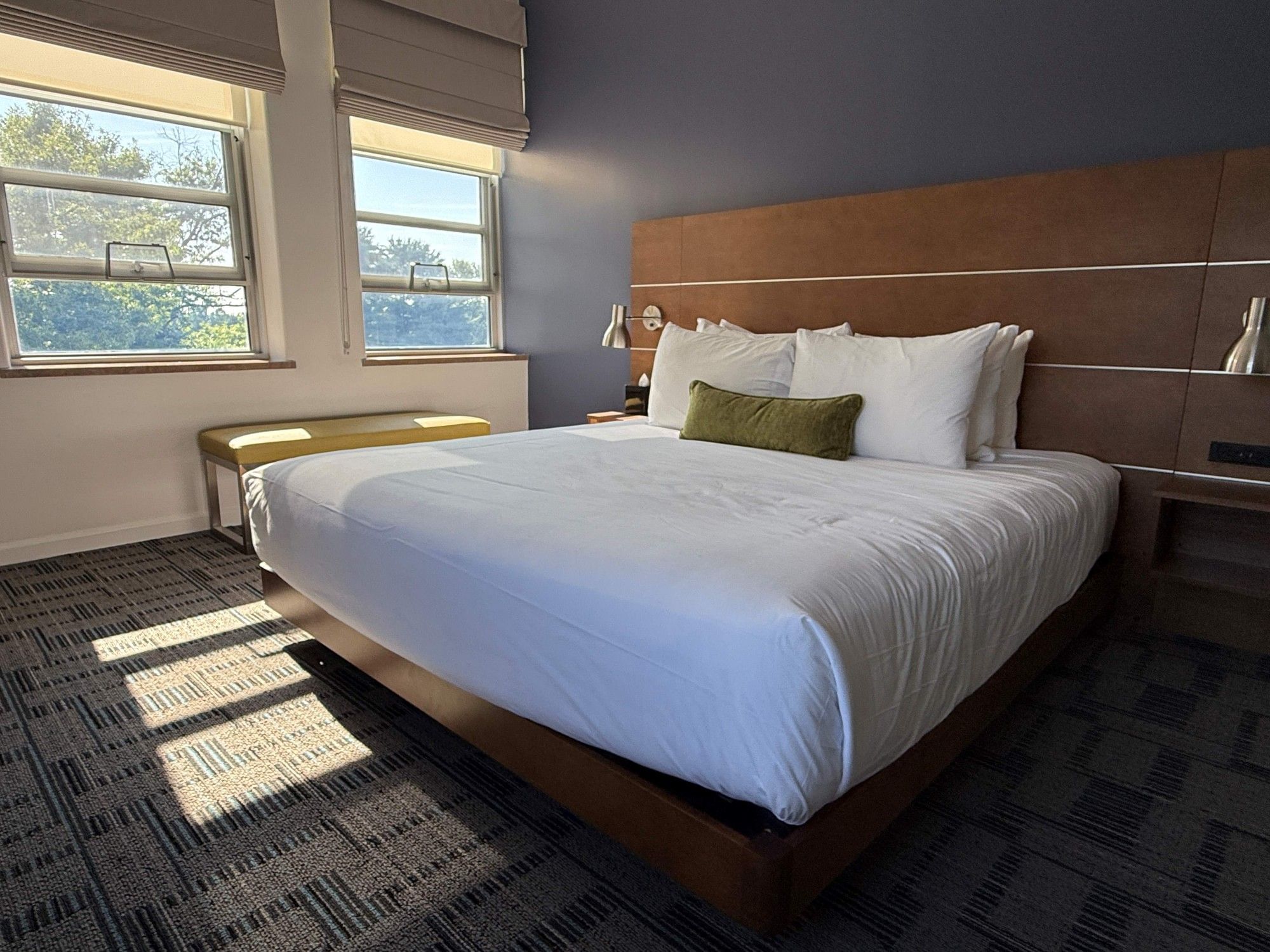 Suite Room at Bolger Center with a large bed and white bedding, located in Potomac, Maryland.