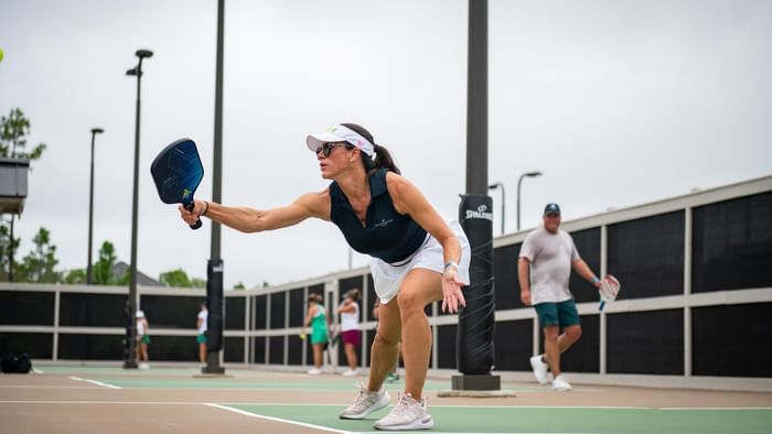 A woman plays pickleball at Camp Creek Inn's racquet center