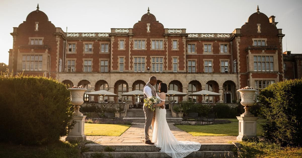 Bride and groom outside of Easthampstead Park one of the best wedding venues in Wokingham