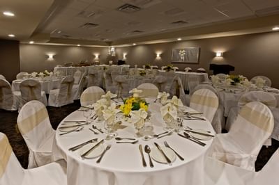 Interior of an event room with banquet setup at Clique Hotels