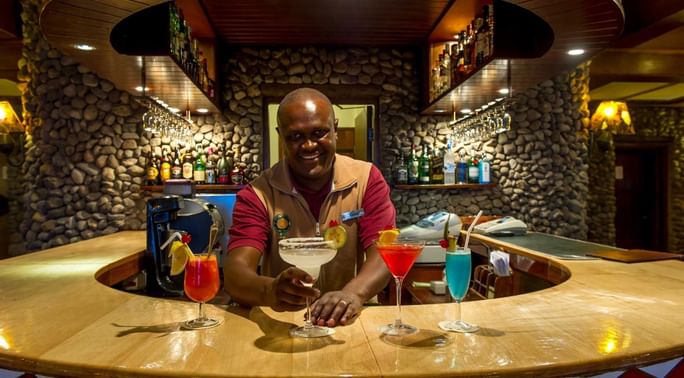 A bartender serving fresh cocktails at Ngorongoro Serena