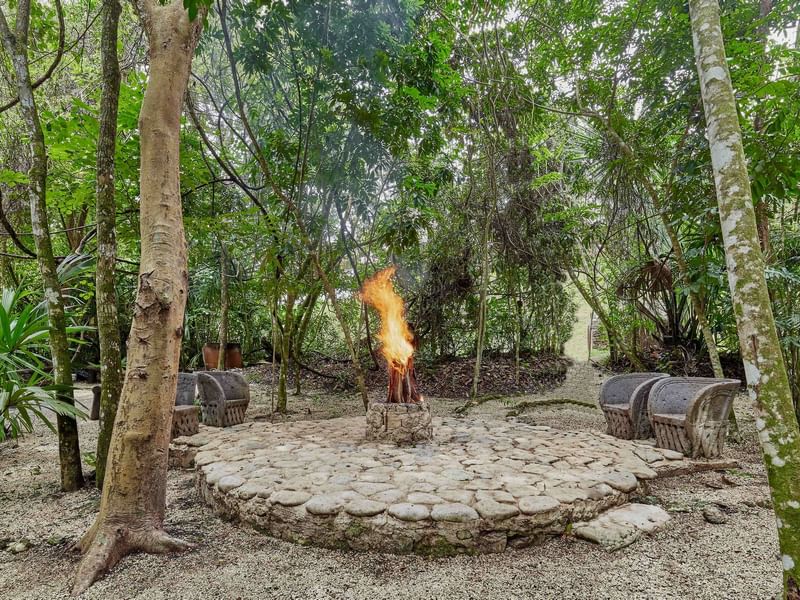 Sitting area with a fire pit at The Explorean Kohunlich