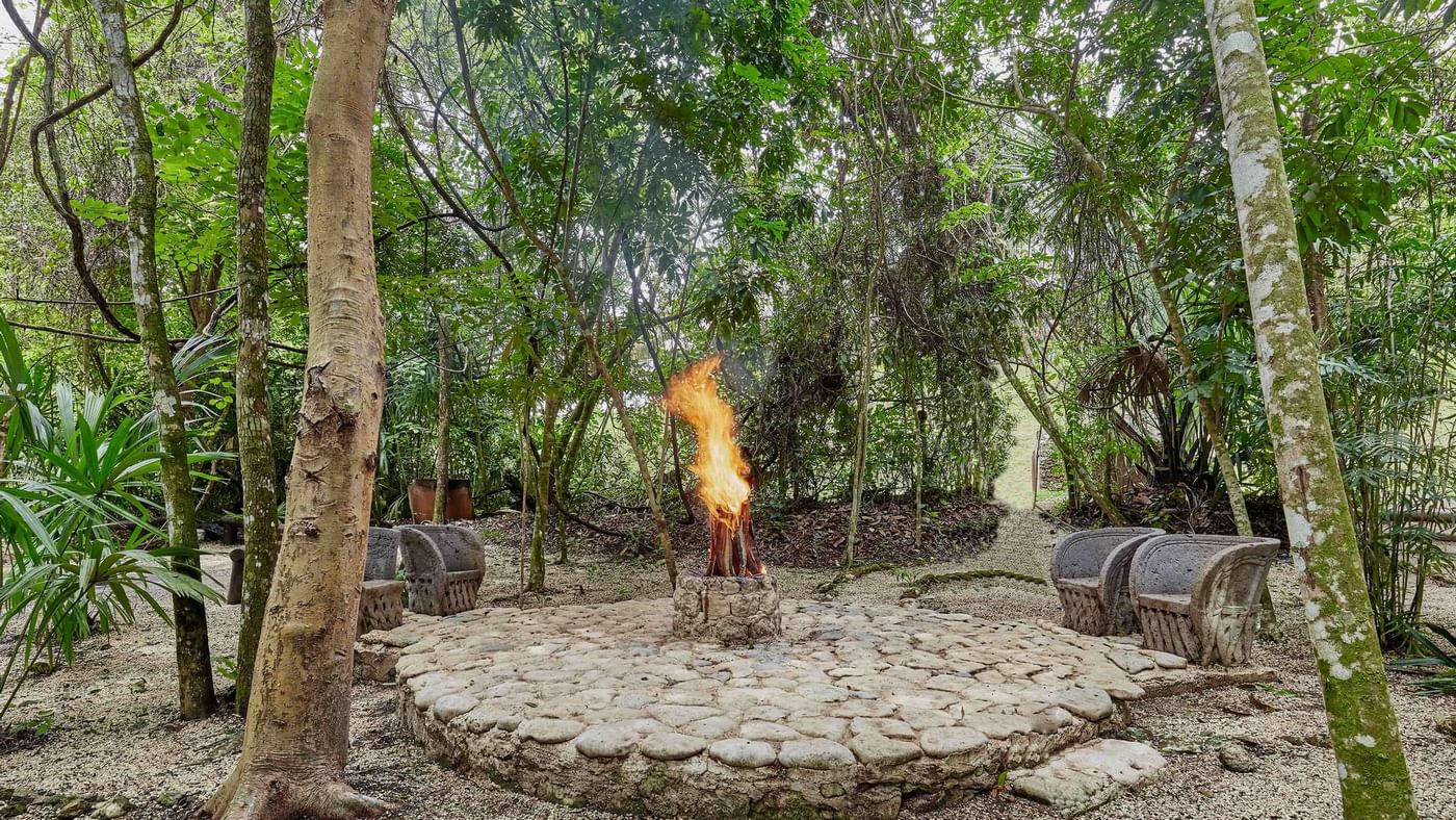 Sitting area with a fire pit at The Explorean Kohunlich