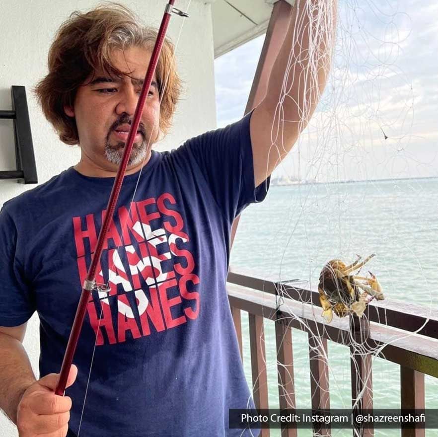 a man showing off his catch while holding a fishing rod - Lexis PD