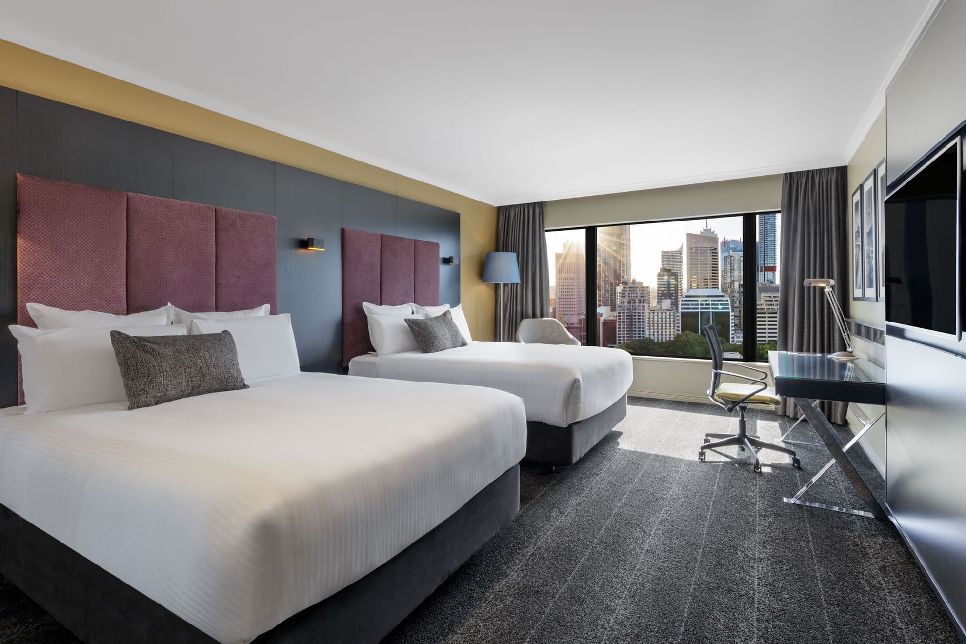 TV & work desk facing the beds in Deluxe Room with carpeted floors at Pullman Sydney Hyde Park