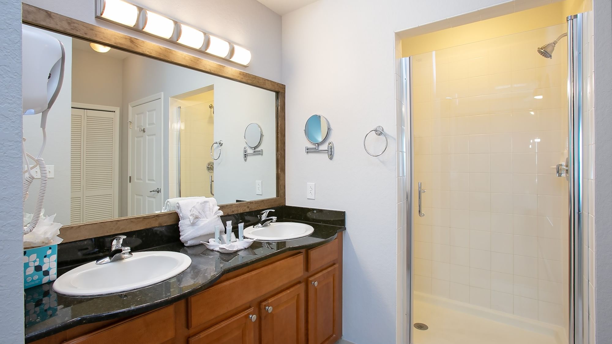 Second primary bathroom with double sinks and walk-in shower