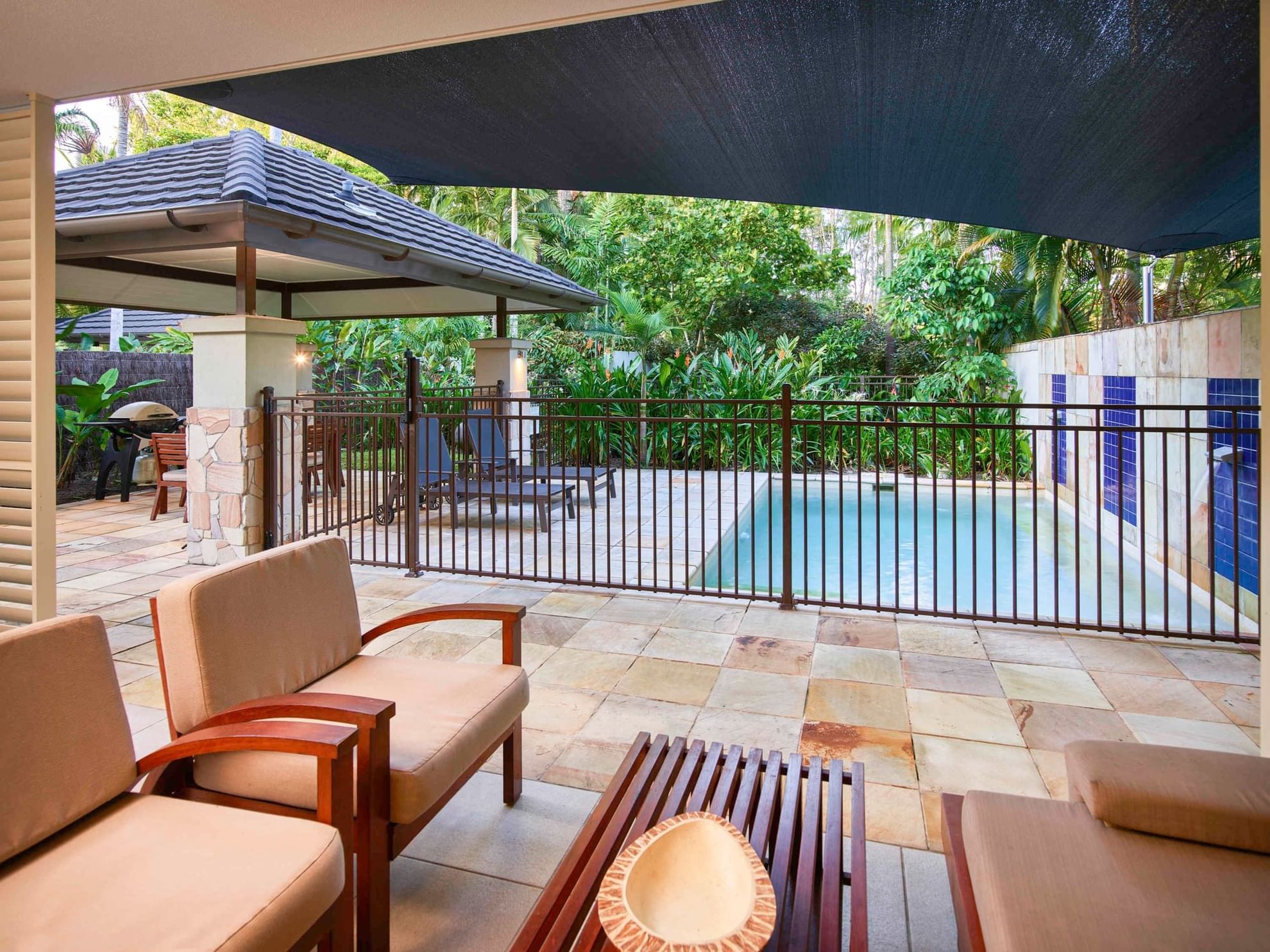 Lounge area with outdoor pool view in Penthouse Apartment at Pullman Port Douglas Sea Temple Resort & Spa