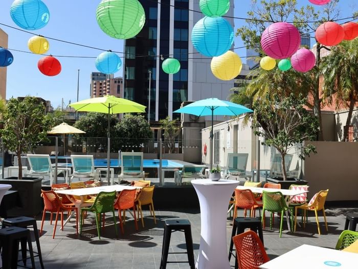 Colorful outdoor dining area with lanterns and umbrellas at Hotel Grand Chancellor Adelaide
