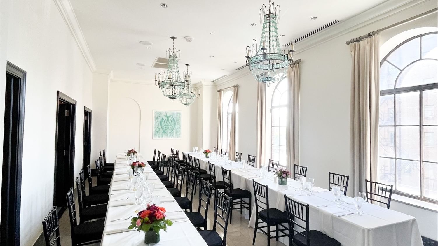 Elegant Card Room with long tables and black chairs at The Mayo Hotel in Tulsa.
