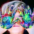 Child with colourful paint on hands