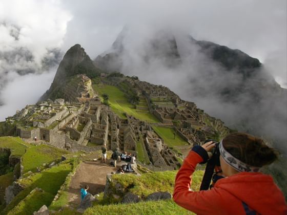Un turista tomando fotos de la montaña cerca de Sumaq Hotel
