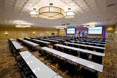 A large corporate event is set up at the Bolger Center Franklin Building with multiple tables and chairs
