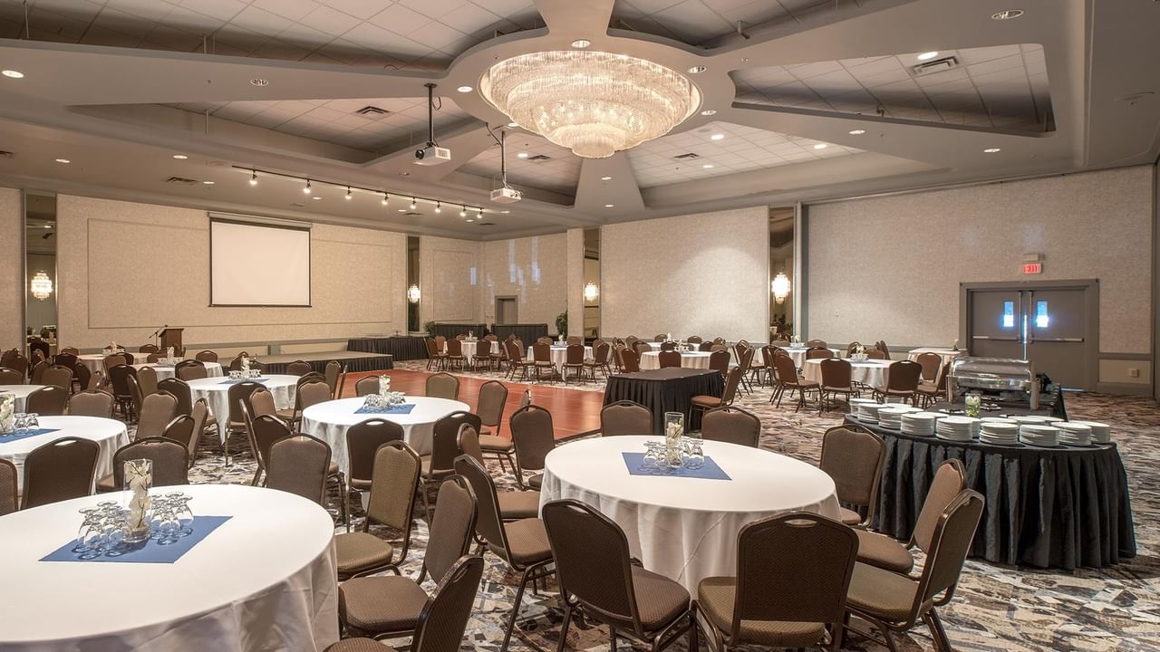 Banquet hall with round tables and chairs.