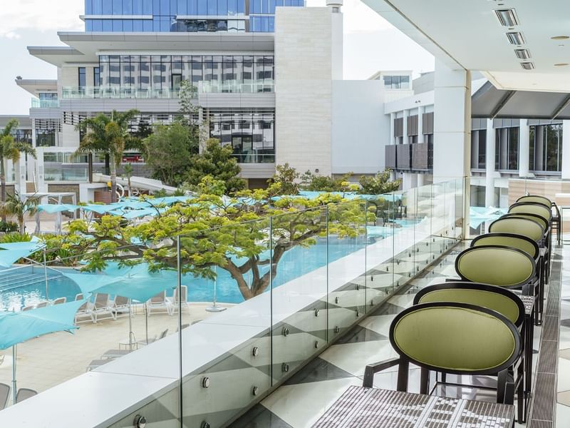 Balcony view of a pool with umbrellas in Bistro Guillaume at Crown Metropol Perth
